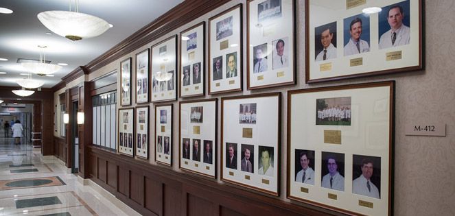 Hall of framed photos of WCM alumi.